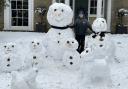 Zac Clark, 12, has been busy making a family of snow people and pets in Melbourn. Pic: Melanie Clark