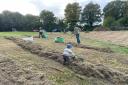 Volunteers helped rake up the grass on Sun Hill Common