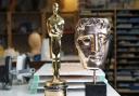 Make-up artist Mark Coulier's Oscar, which he won for 'The Iron Lady', and the BAFTA he won for 'The Grand Budapest Hotel'