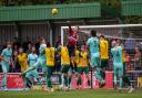 Charlie Horlock of Hitchin Town punches clear as Royston Town press at Top Field.