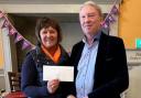 Tracy Aggett received the cheque from Paul Bowes of Bow Books