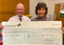 David Powell from Royston Bowling Club presenting the cheque to Tracy Aggett from Home-Start