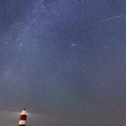 A meteor during the Perseid meteor shower seen over Happisburgh lighthouse, Norfolk, taken in August 2021.
