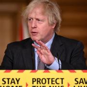 PM Boris Johnson introducing COVID-19 restrictions last year