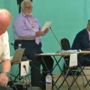 Tory opposition leader Steve Count packs up as he prepares to head for the exit, abandoning a full meeting of the county council in July. It was being chaired by Cllr Derek Giles (second left) who has stepped down because of ill-health.