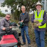 Volunteers clearing the overgrown path ahead of the A10 Awareness Ride and Walk