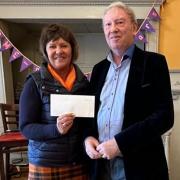 Tracy Aggett received the cheque from Paul Bowes of Bow Books