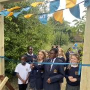 Pupils cut the ribbon for the new outdoor space at KJAR