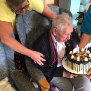 Ron Roberts blowing out the candles on his 102nd birthday cake