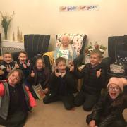 Enid celebrating her 101st birthday with children from Barley and Barkway First Schools