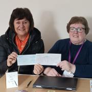 Tracy Aggett from Home-Start Royston, Buntingford and South Cambs receiving a cheque from Joyce Goodall of Royston Pasque Flowers WI