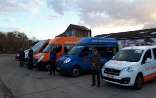 Some of RDCT's volunteer drivers with their fleet of vehicles